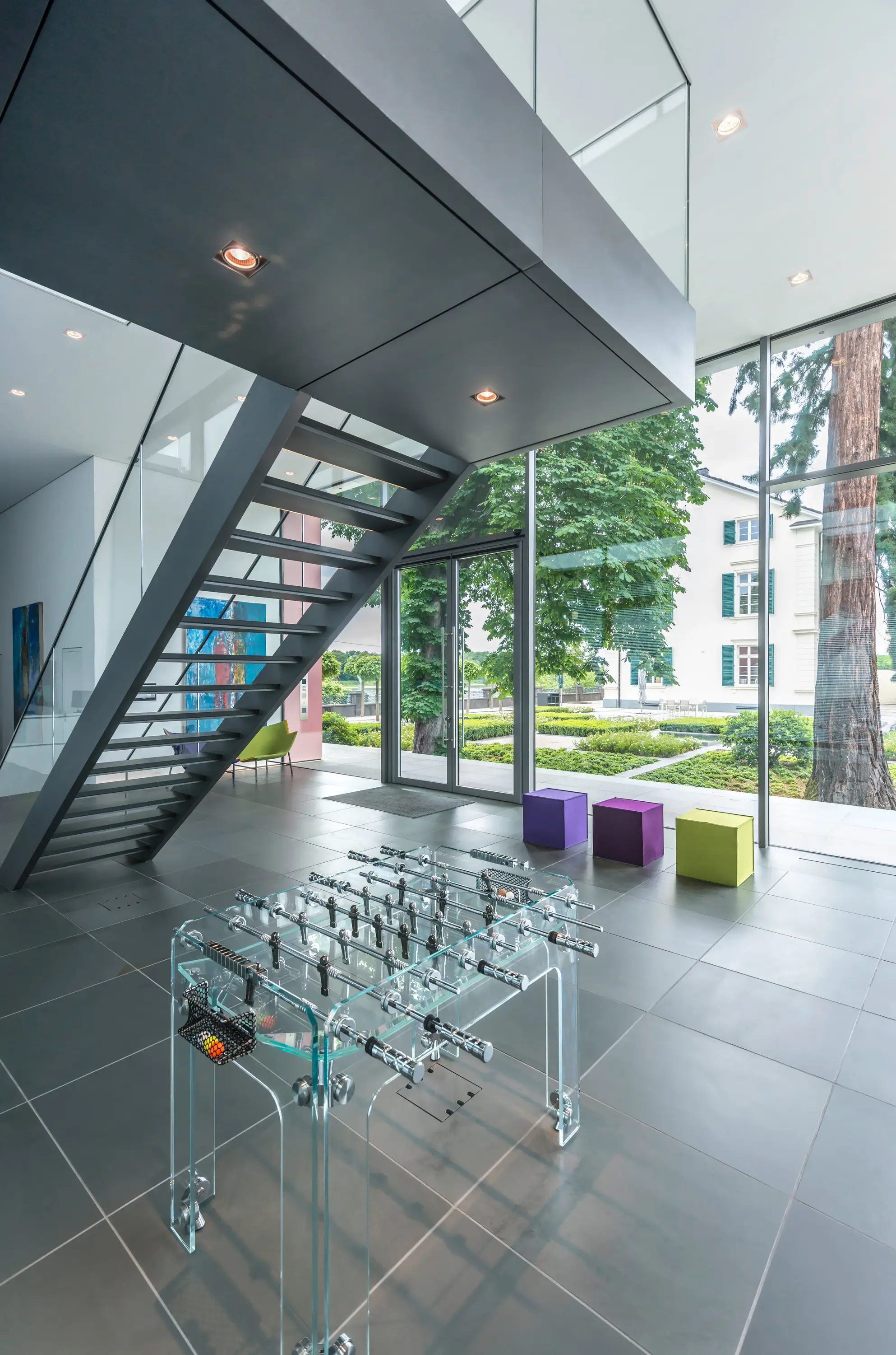 Treppe mit Glasgeländer im hellen Innenraum